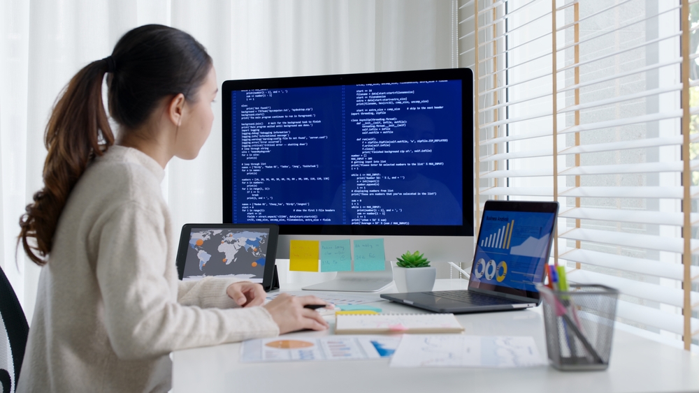 Woman visualizing code on her computer